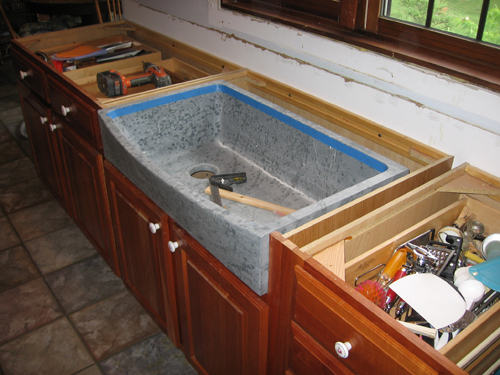 The sink being fitted into the cabinet